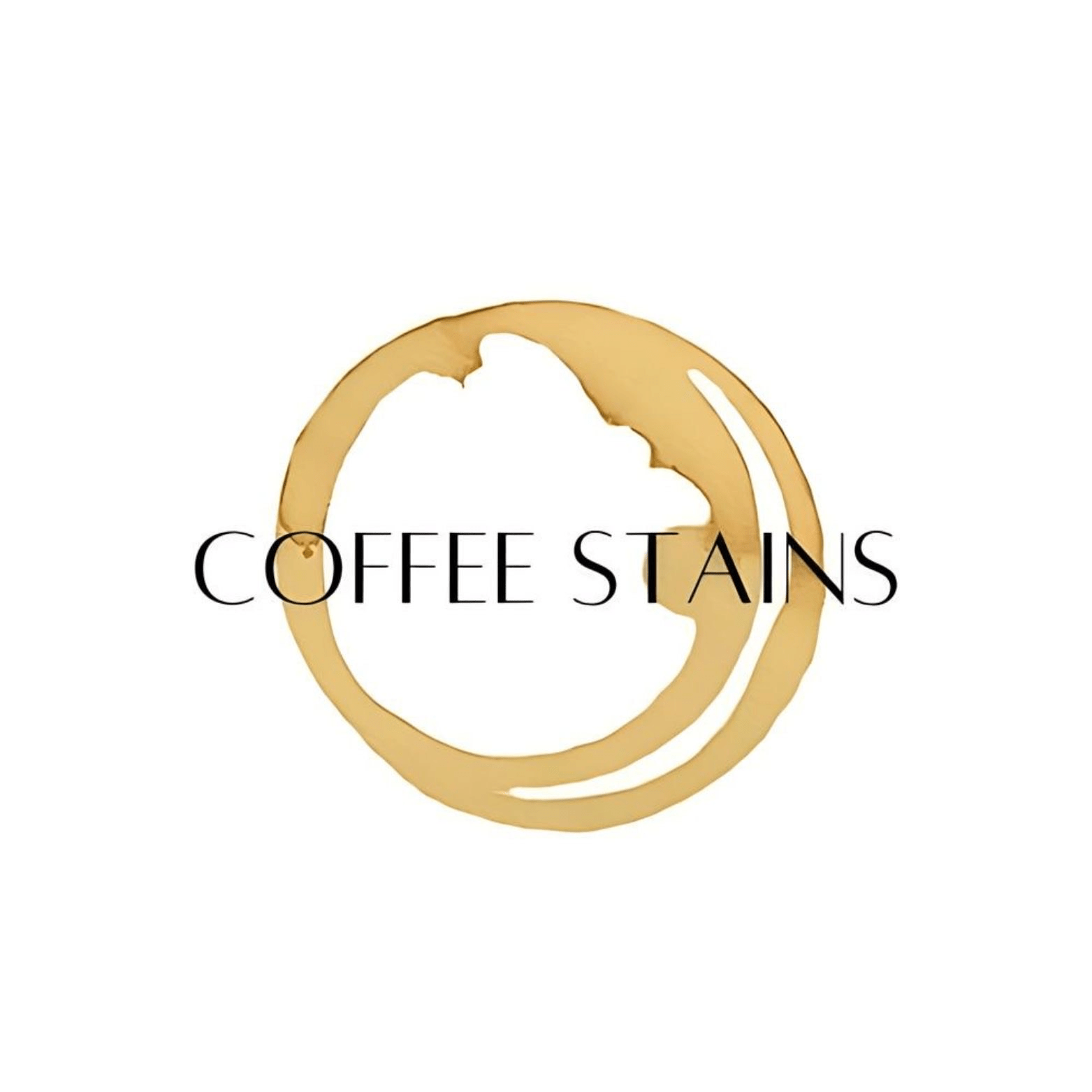 A brown coffee cup stain ring with the words "COFFEE STAINS" written in black capital letters across the center on a white background.