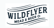 Logo for Wildflyer Mead & Beer Co., featuring the company name in bold, wavy, uppercase letters with decorative lines above and below the text.